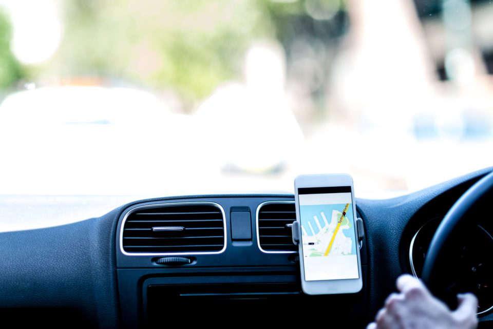 Driver using GPS on phone to follow the route.