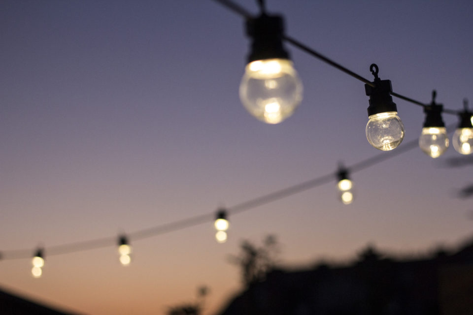 Outdoor string lights hanging in line.