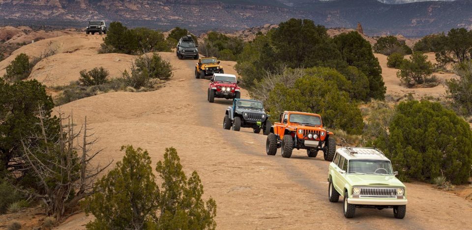 Jeeps driving in a line on a dirt road