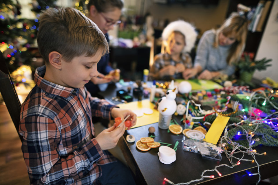 Family crafting Christmas cards and decorations