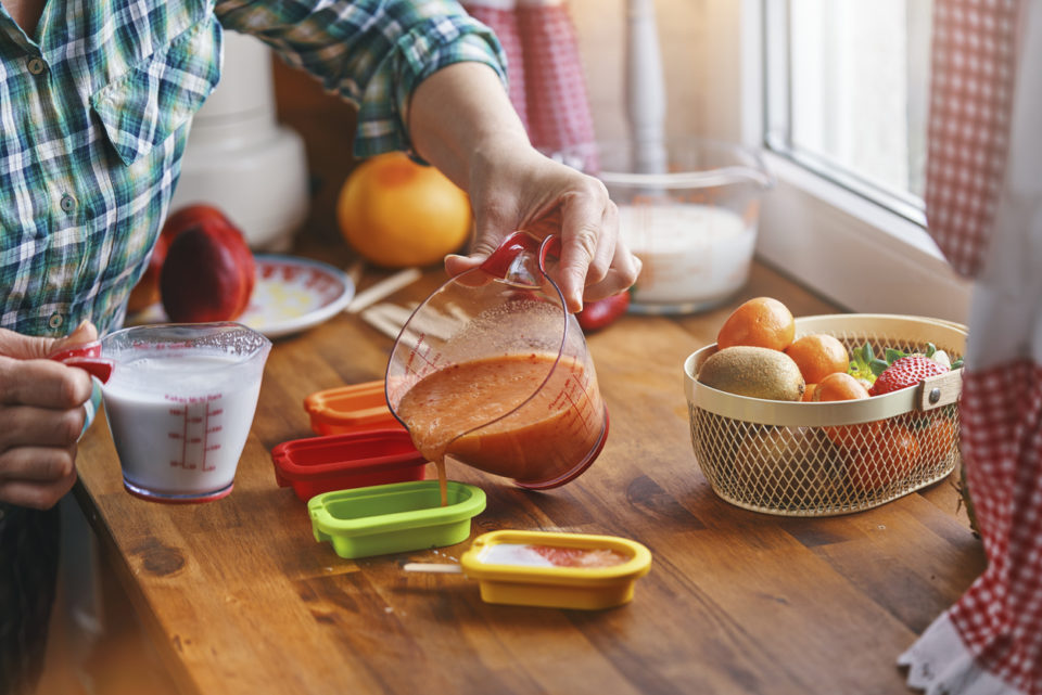 Preparing Fruit Ice Cream on Stick in Domestic Kitchen