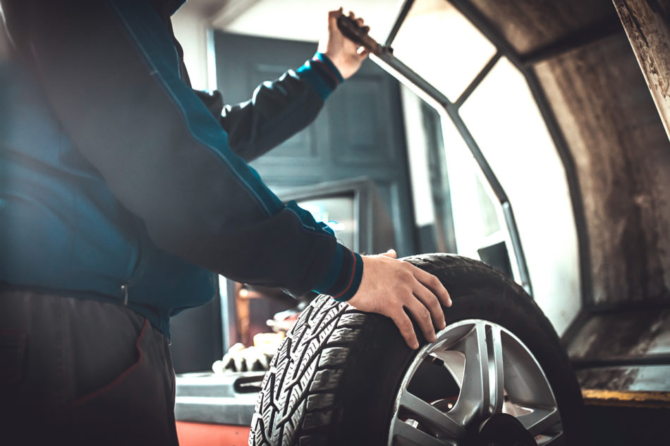 One mechanic balancing a tire in auto repair shop