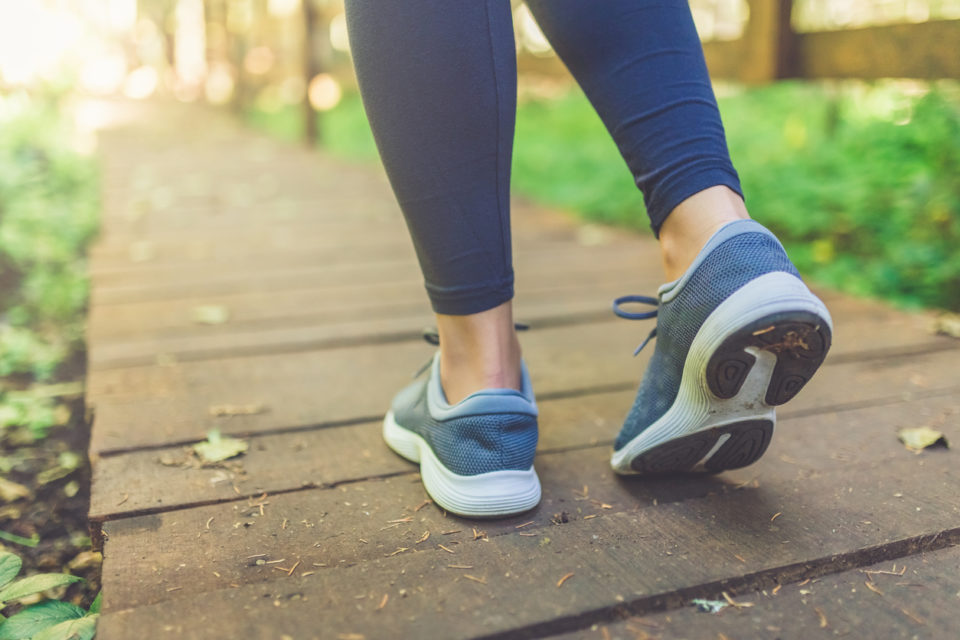 woman walking on a trail in the woods