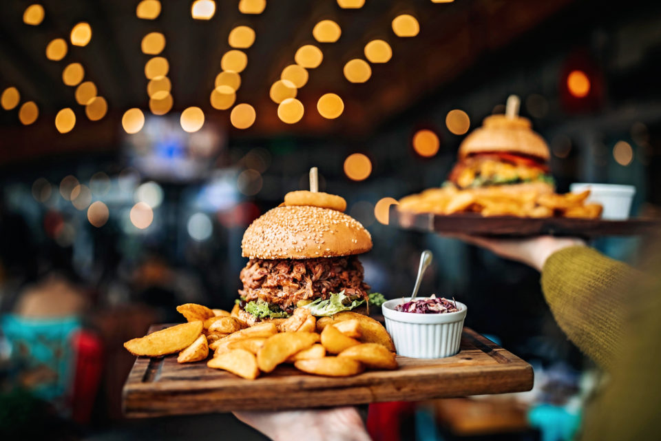 Woman carrying burger