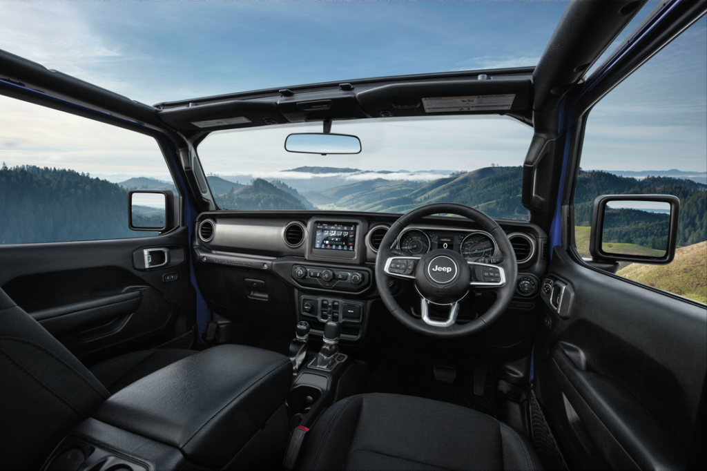 2022 Jeep Wrangler interior with roof and doors removed revealing scenic view