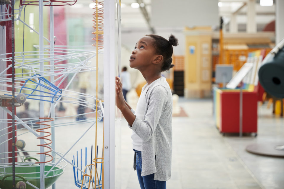 young girl looking at exhibit