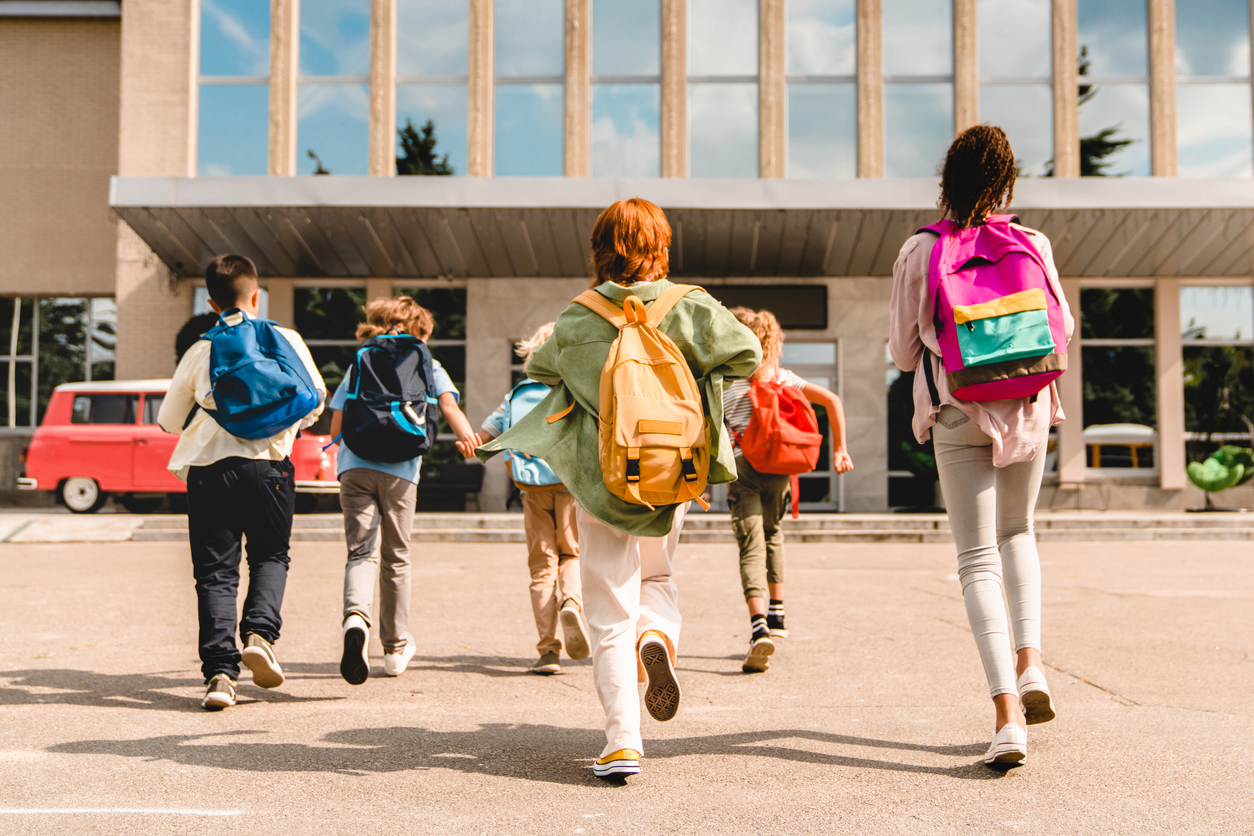 students running into school on first day