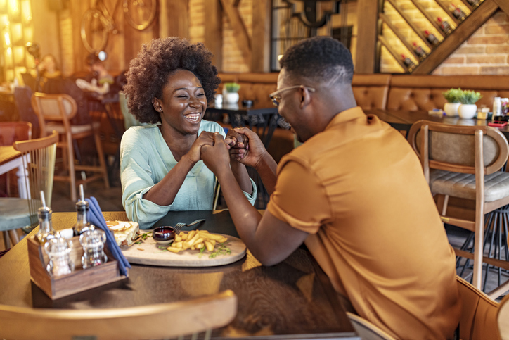 an affectionate young couple having a romantic dinner in a restaurant