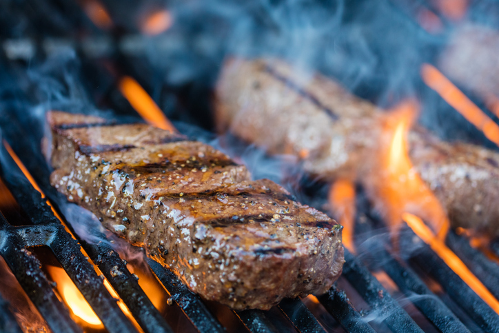 Close-up shot of two sirloin steaks on the bbq.