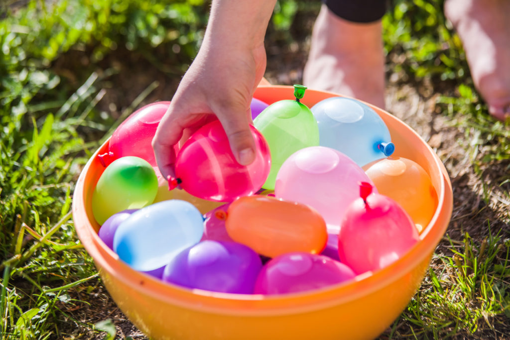 Colorful water balloons sitting in bucket