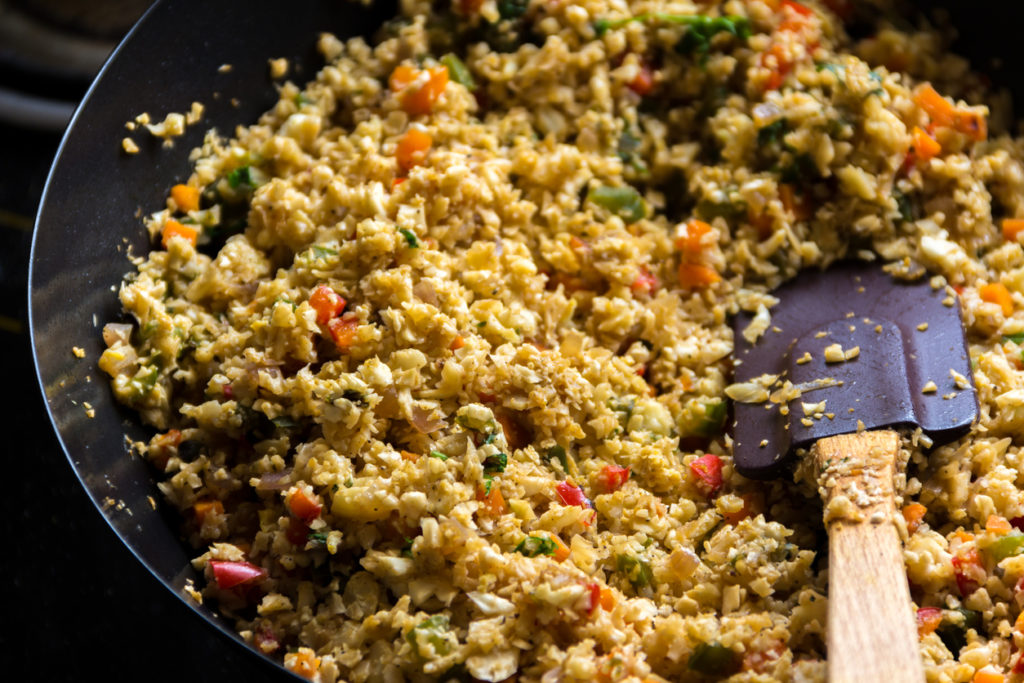 Cauliflower rice in a skillet close-up image.