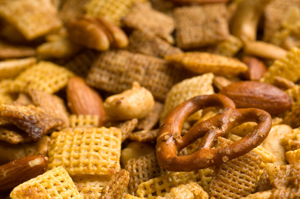 Close Up of cereal, pretzel, and nut snack mix background
