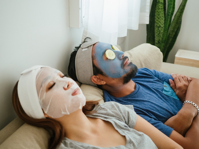 Happy time, couple applying facial masks